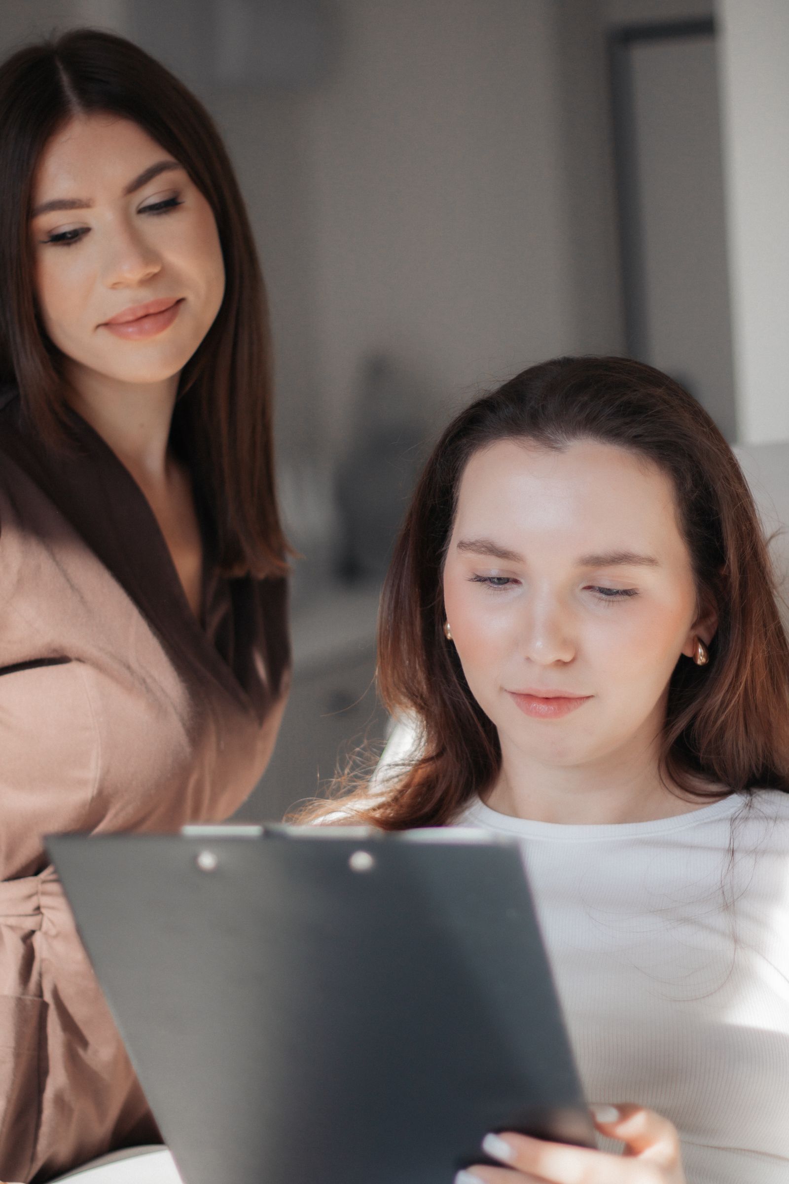 Two colleagues reviewing documents together at a desk
